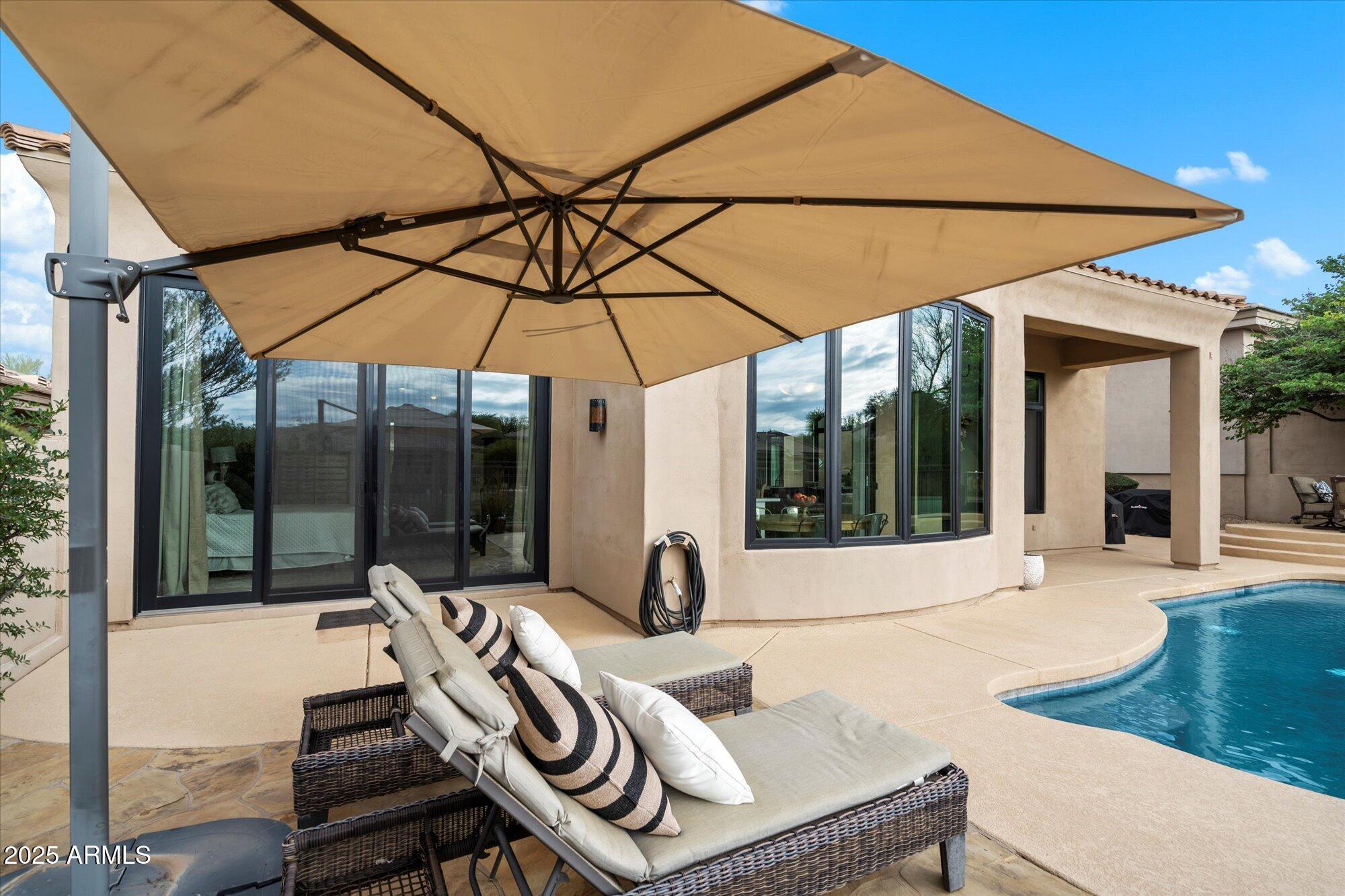10747 East Greenway Road Scottsdale, AZ 85255 - Photo 32 of 56 a view of a patio with a table and chairs under an umbrella
