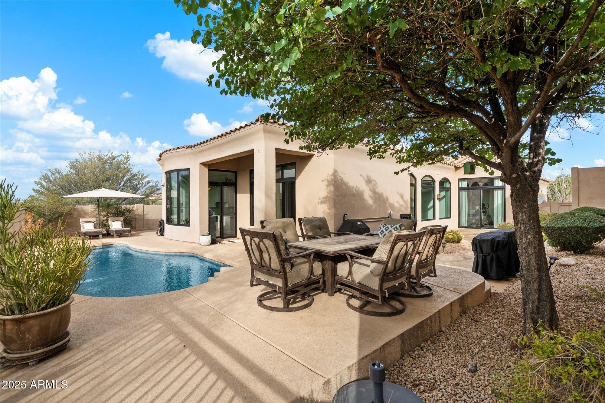 10747 East Greenway Road Scottsdale, AZ 85255 - Photo 4 of 56 a view of a patio with couches table and chairs and potted plants