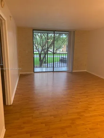 a view of wooden floor and an empty room