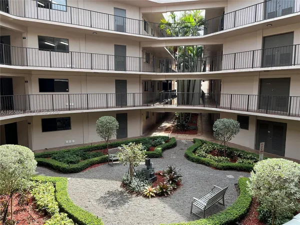 a view of a house with yard and sitting area