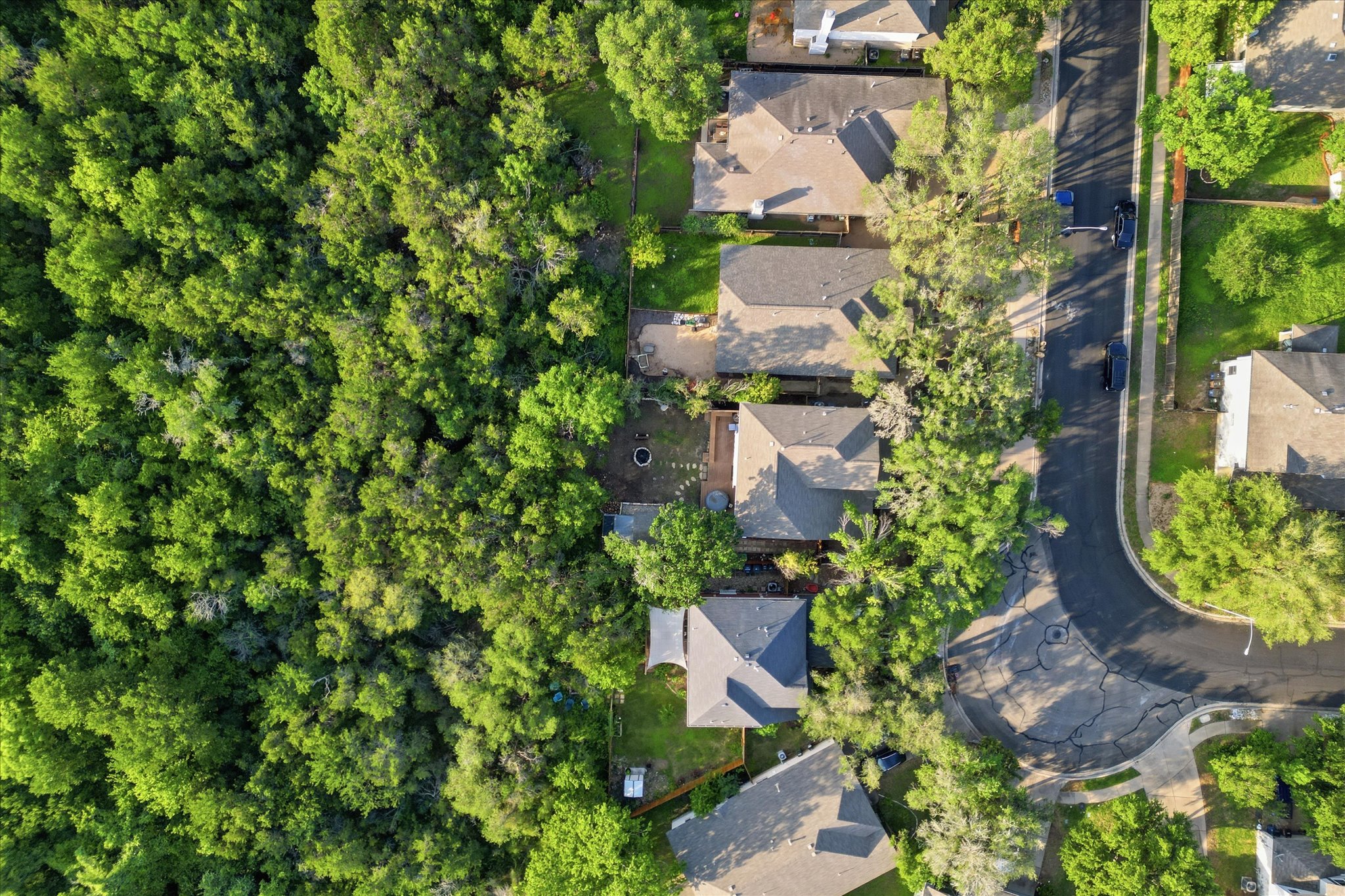 8920 West Hove Loop Austin, TX 78749 - Photo 25 of 39 Aerial perspective showcasing a residential street bordered by dense tree coverage