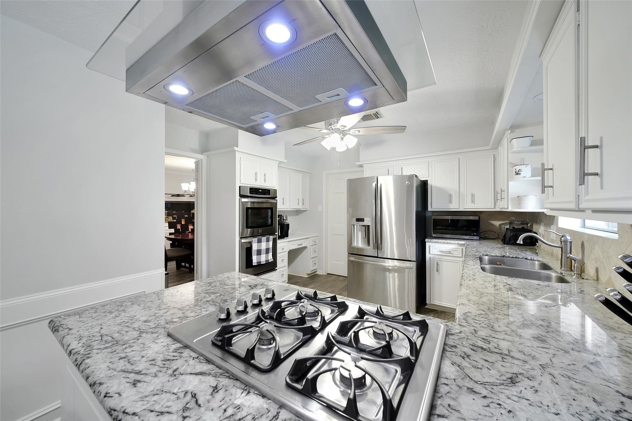 6522 Castle Pine Lane Spring, TX 77379 - Photo 14 of 38 a kitchen with stainless steel appliances kitchen island granite countertop a refrigerator and a stove top oven