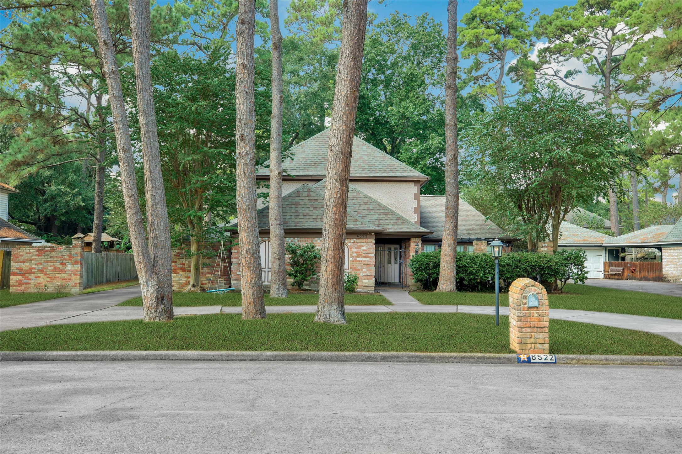 6522 Castle Pine Lane Spring, TX 77379 - Photo 2 of 38 a front view of a house with a yard and large trees