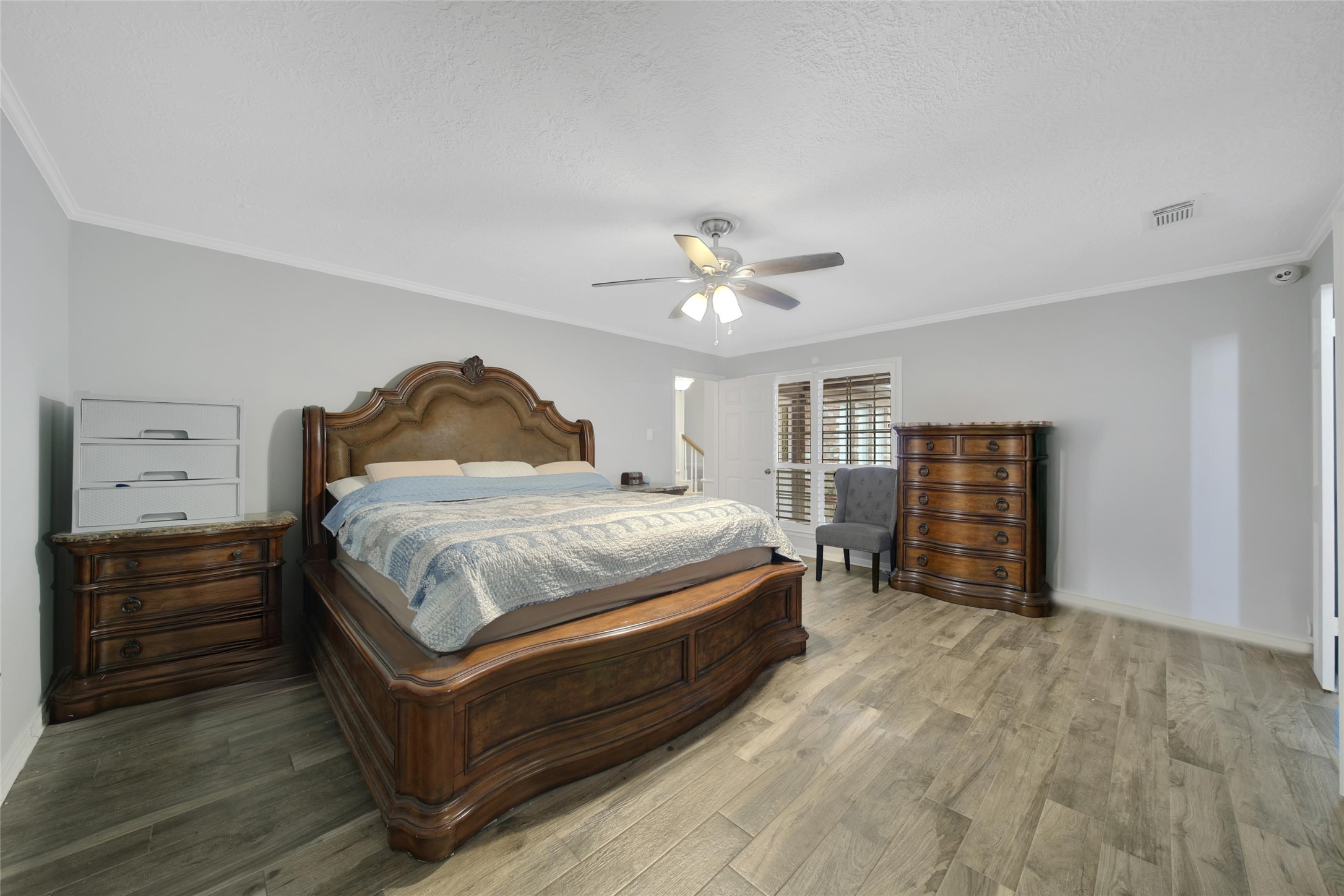 6522 Castle Pine Lane Spring, TX 77379 - Photo 21 of 38 a spacious bedroom with a bed and a chandelier