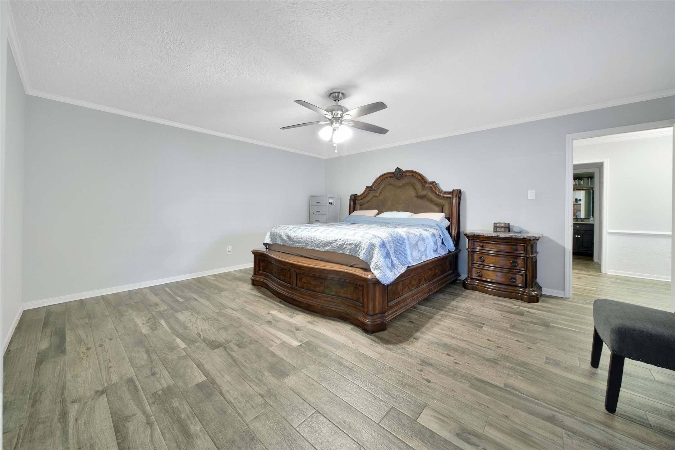 6522 Castle Pine Lane Spring, TX 77379 - Photo 22 of 38 a spacious bedroom with a bed and a chandelier