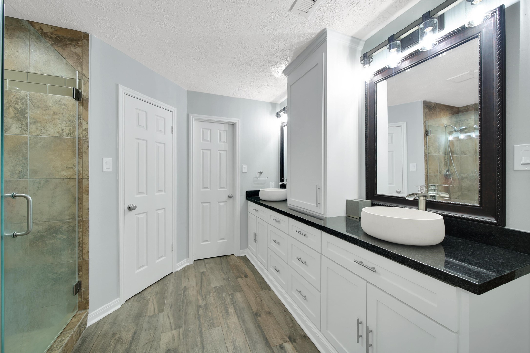 6522 Castle Pine Lane Spring, TX 77379 - Photo 24 of 38 a bathroom with a granite countertop double vanity sink a mirror and a shower