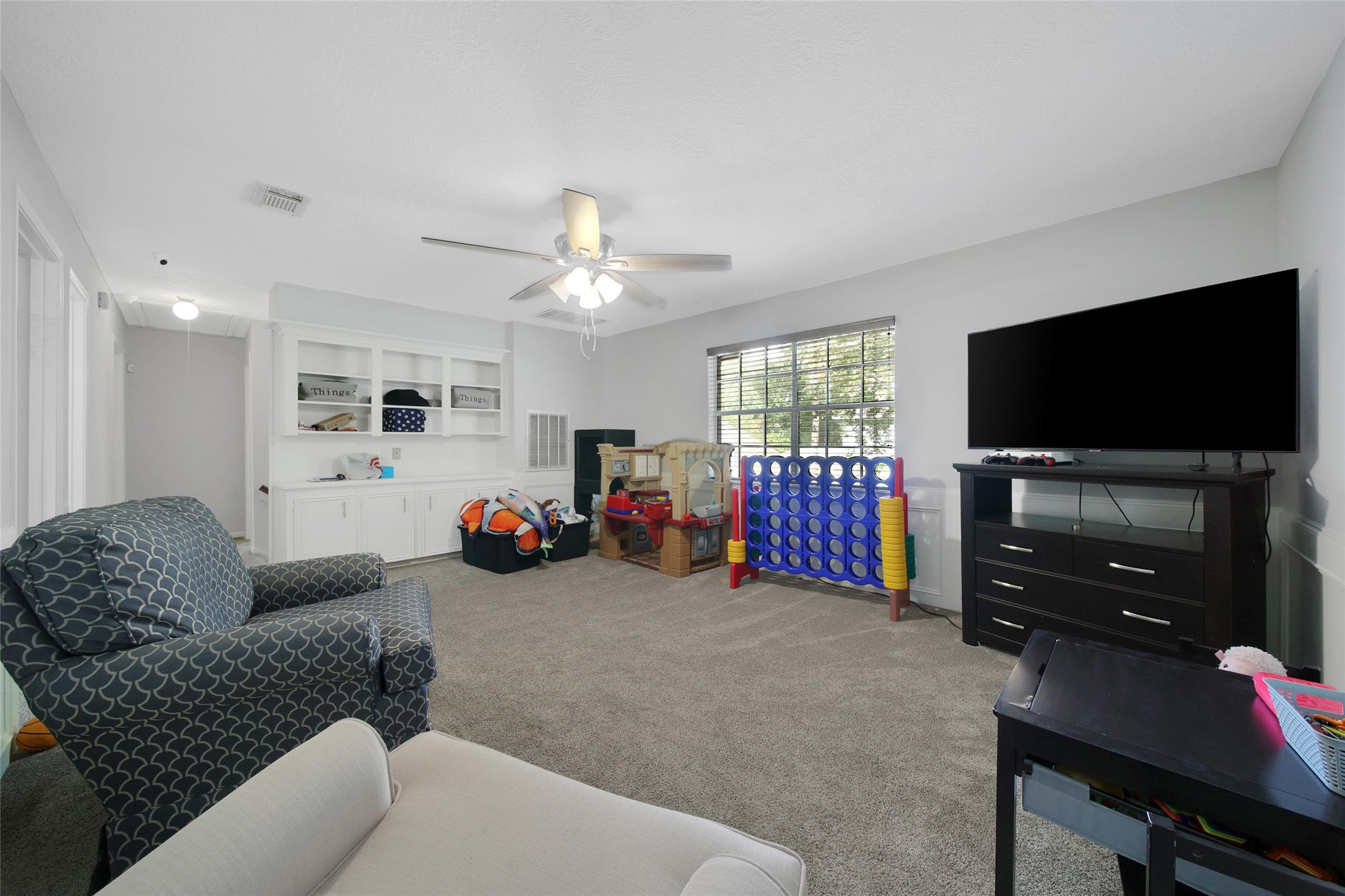 6522 Castle Pine Lane Spring, TX 77379 - Photo 28 of 38 a living room with furniture and a flat screen tv