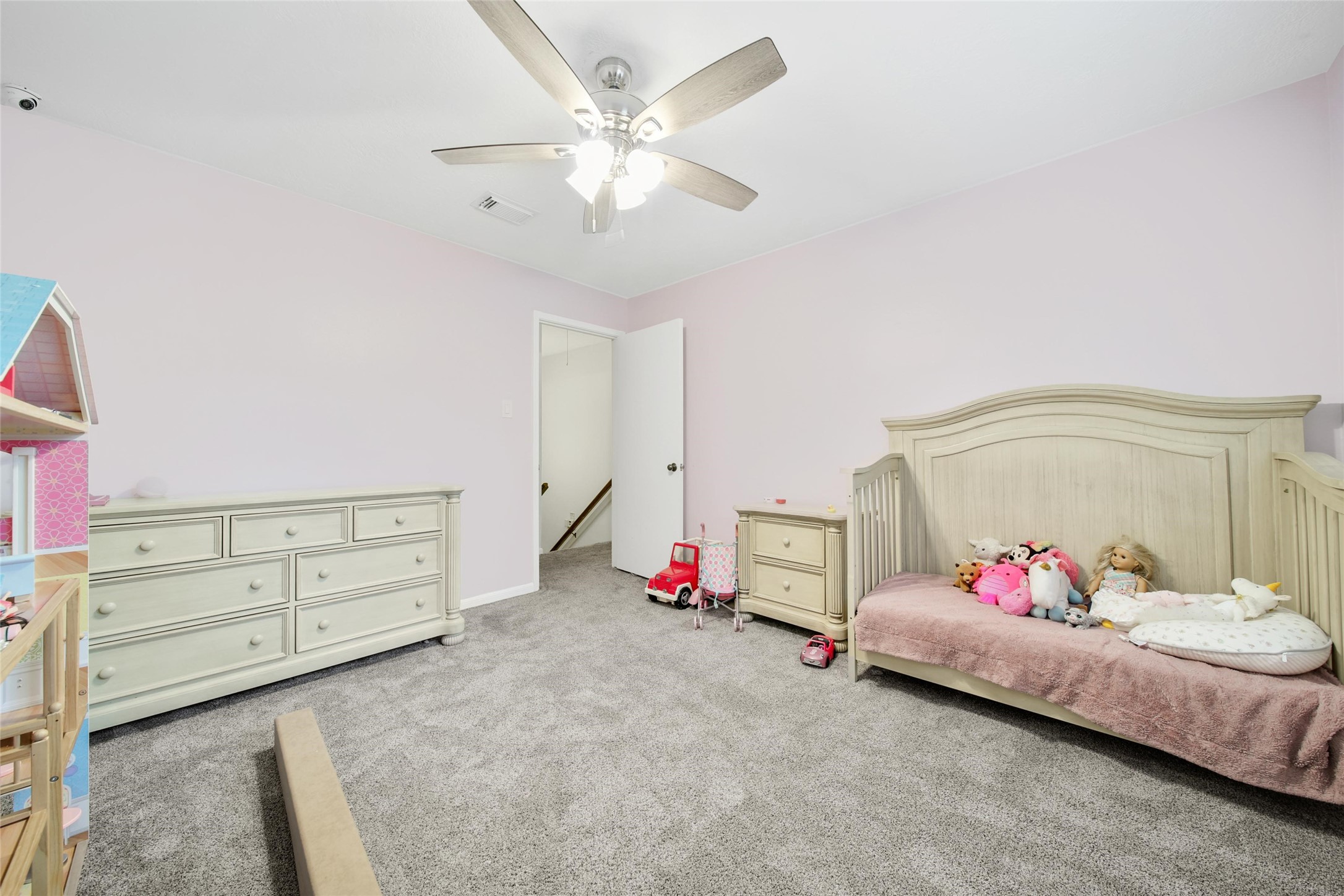 6522 Castle Pine Lane Spring, TX 77379 - Photo 33 of 38 a bedroom with a bed and a chandelier