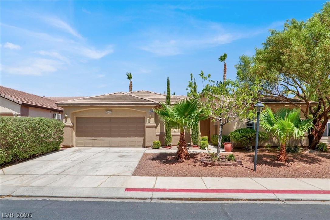 7308 Rustic Meadow Street Las Vegas, NV 89131 - Photo 1 of 27 A desert-friendly landscape surrounds this welcoming home with a two-car garage and concrete driveway.