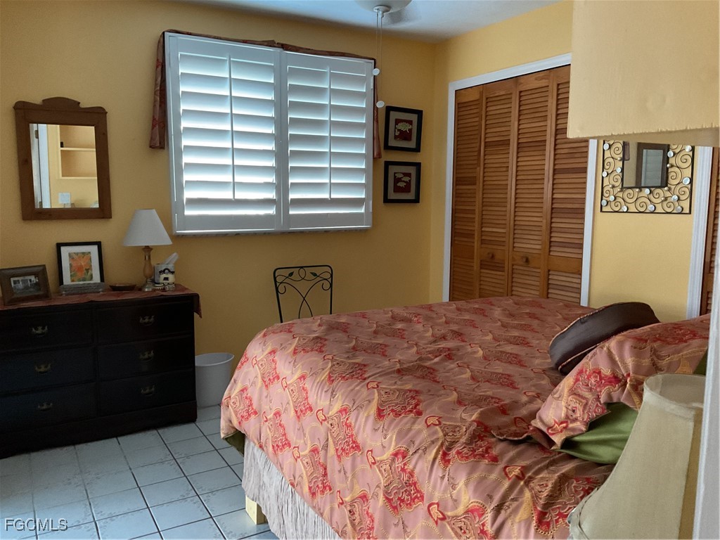 1002 Michael Avenue Lehigh Acres, FL 33936 - Photo 19 of 34 a bedroom with a bed and a window