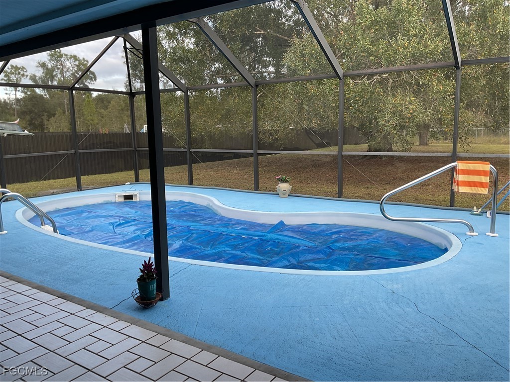 1002 Michael Avenue Lehigh Acres, FL 33936 - Photo 21 of 34 a view of a room with wooden floor and fence