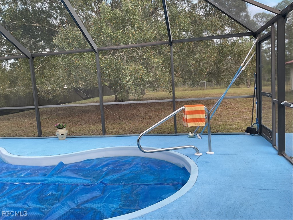 1002 Michael Avenue Lehigh Acres, FL 33936 - Photo 25 of 34 a view of a room with wooden floor and door