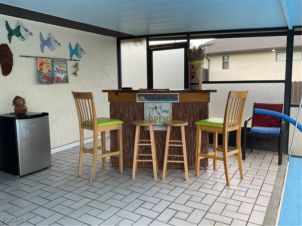 1002 Michael Avenue Lehigh Acres, FL 33936 - Photo 28 of 34 a dining room with furniture and a rug