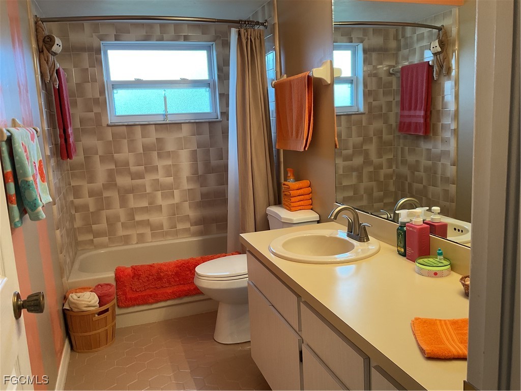 1002 Michael Avenue Lehigh Acres, FL 33936 - Photo 30 of 34 a bathroom with a sink toilet and shower