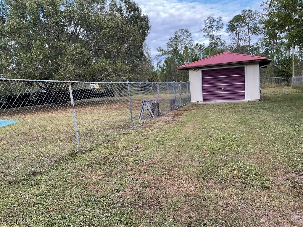 1002 Michael Avenue Lehigh Acres, FL 33936 - Photo 7 of 34 a backyard of a house with barbeque oven