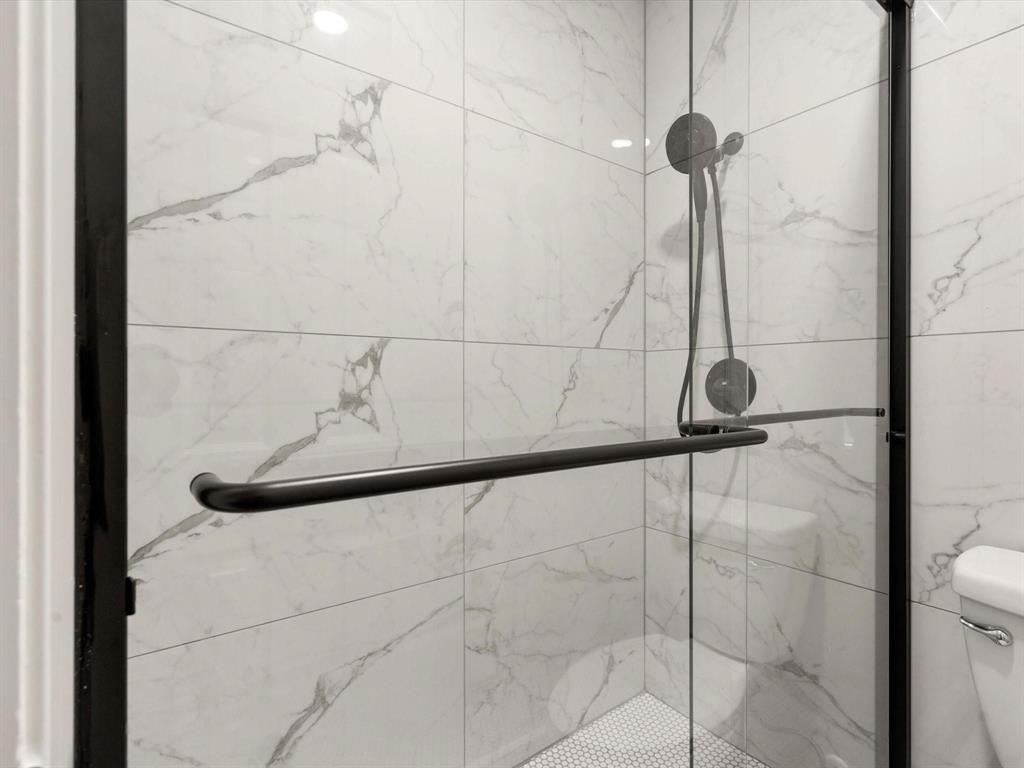 1117 South Rusk Street, Unit 1117 Weatherford, TX 76086 - Photo 7 of 16 Bathroom view of a marble finish shower and toilet