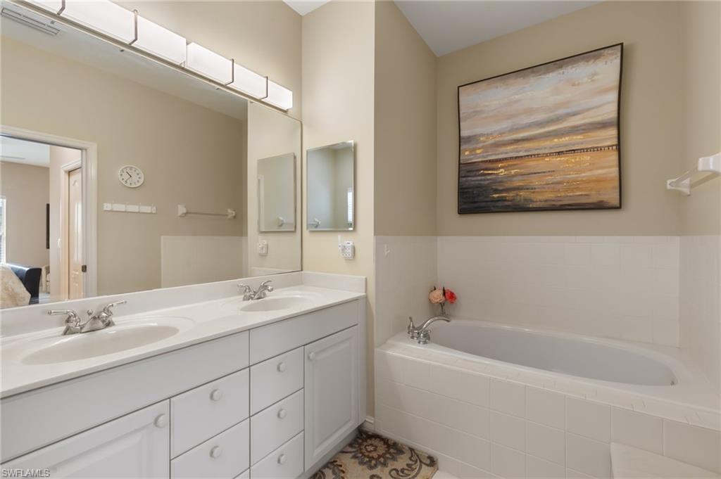 8140 Chancel Court, Unit 2 Naples, FL 34104 - Photo 16 of 39 Ensuite bathroom with double vanity and a bath