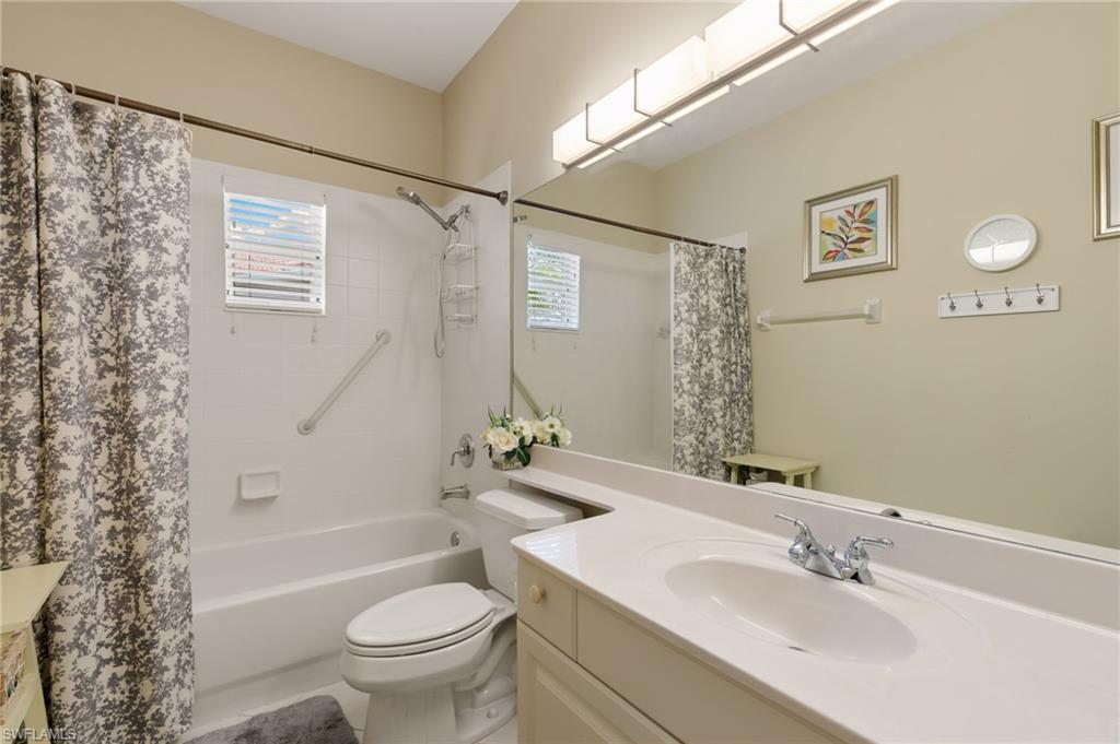 8140 Chancel Court, Unit 2 Naples, FL 34104 - Photo 18 of 39 Bathroom featuring vanity, shower / tub combo with curtain, and plenty of natural light