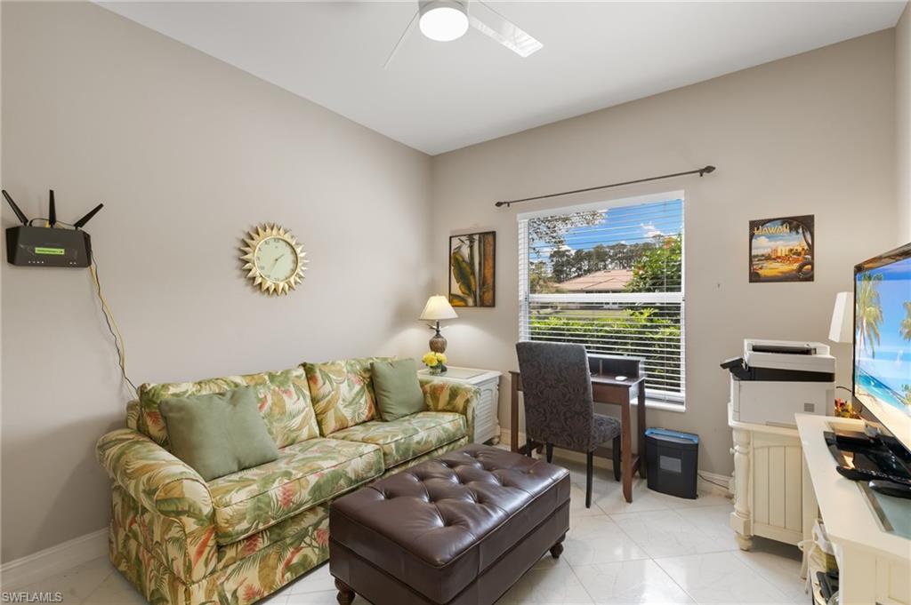 8140 Chancel Court, Unit 2 Naples, FL 34104 - Photo 20 of 39 Living area featuring baseboards and a ceiling fan