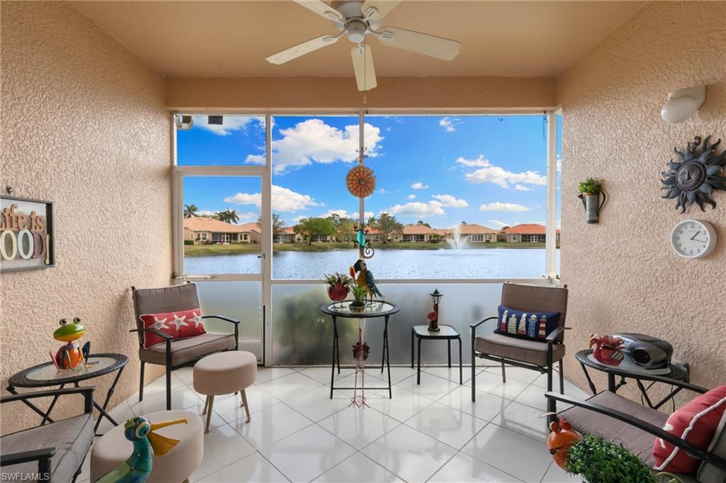8140 Chancel Court, Unit 2 Naples, FL 34104 - Photo 22 of 39 Sunroom featuring a textured wall, a residential view, and a water view