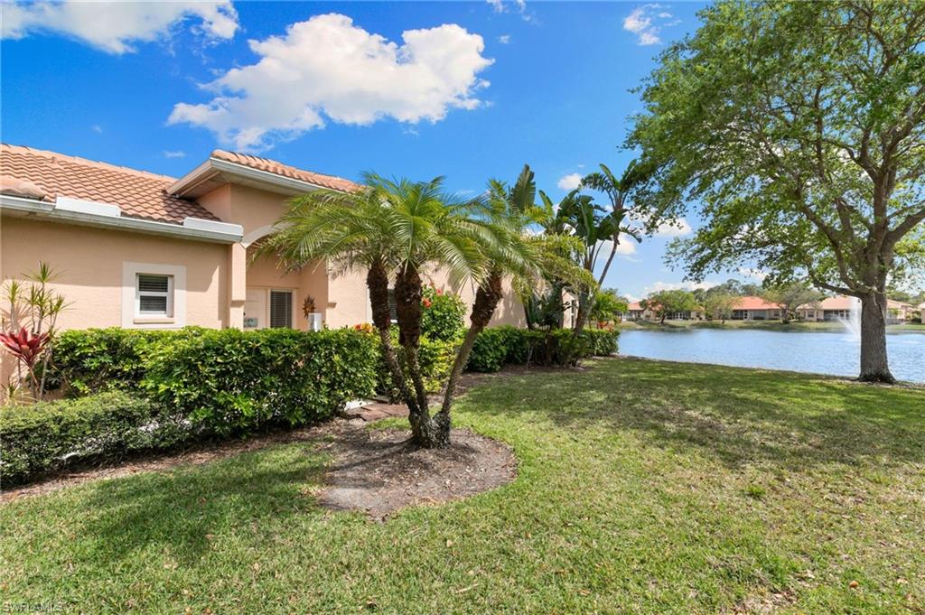 8140 Chancel Court, Unit 2 Naples, FL 34104 - Photo 27 of 39 View of grassy yard featuring a water view
