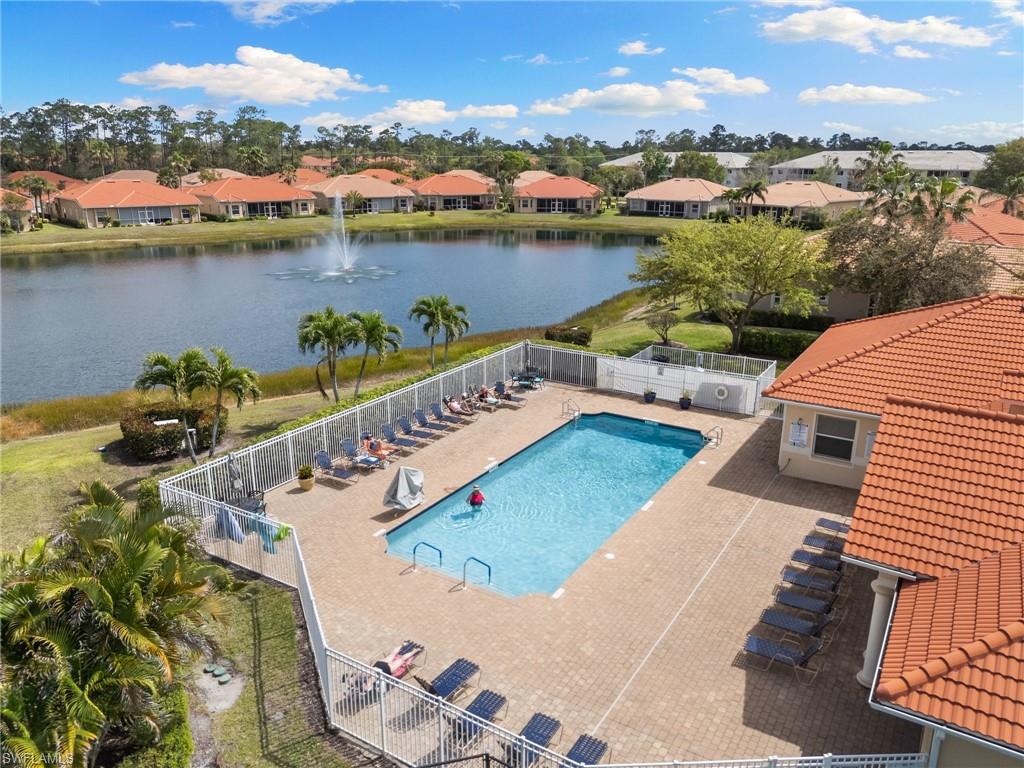 8140 Chancel Court, Unit 2 Naples, FL 34104 - Photo 39 of 39 Community pool featuring a residential view, a patio area, and a water view