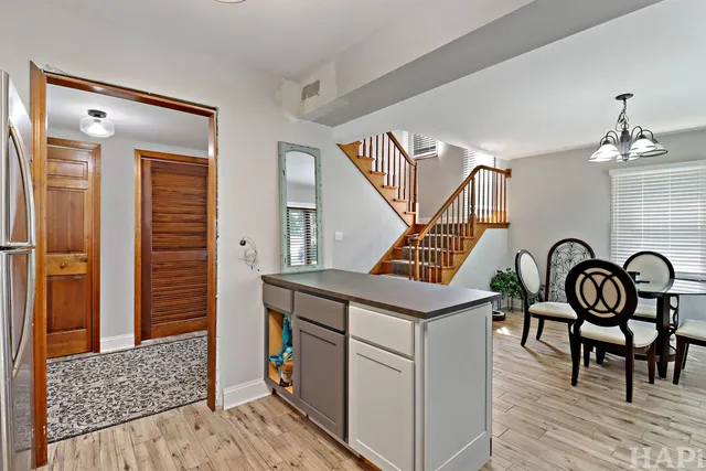 a view of a dining room with furniture wooden floor and staircase