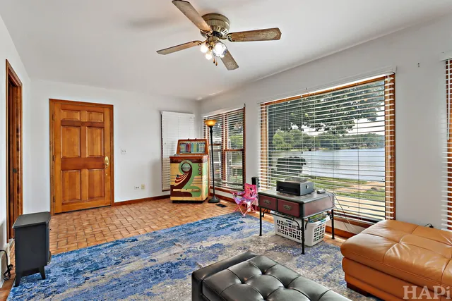 a bathroom with a tub a sink and a window