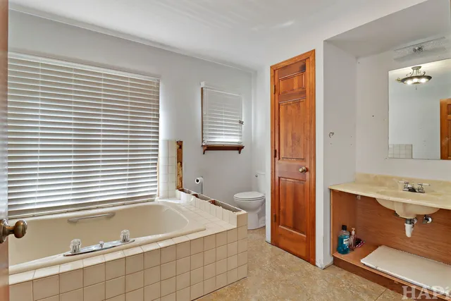 a bathroom with a tub and a sink