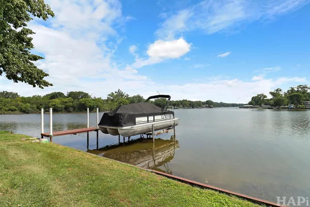 a view of a lake with couches in the patio