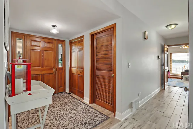 a view of a hallway with furniture and windows