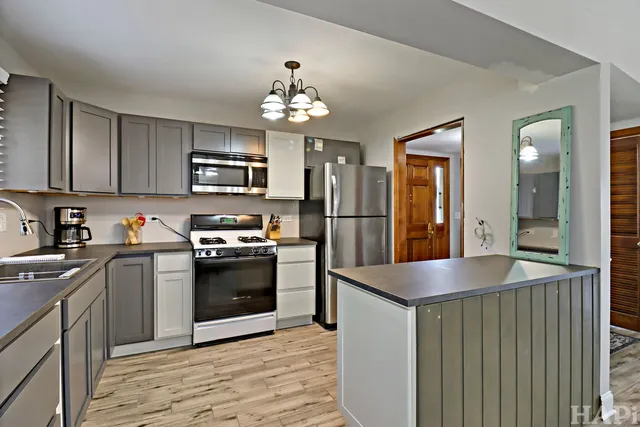 a kitchen with a refrigerator and a sink