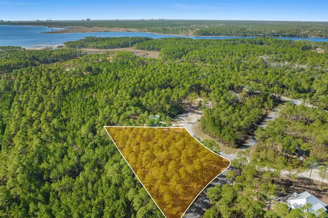 a view of a field with an ocean view