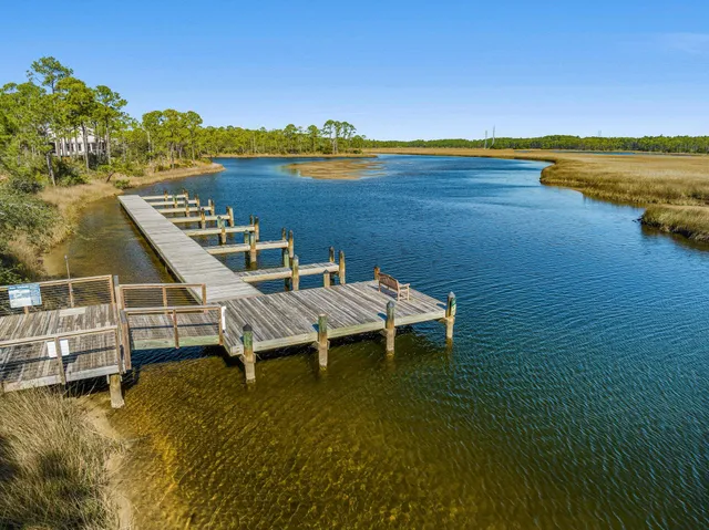 a view of a lake with couches chairs