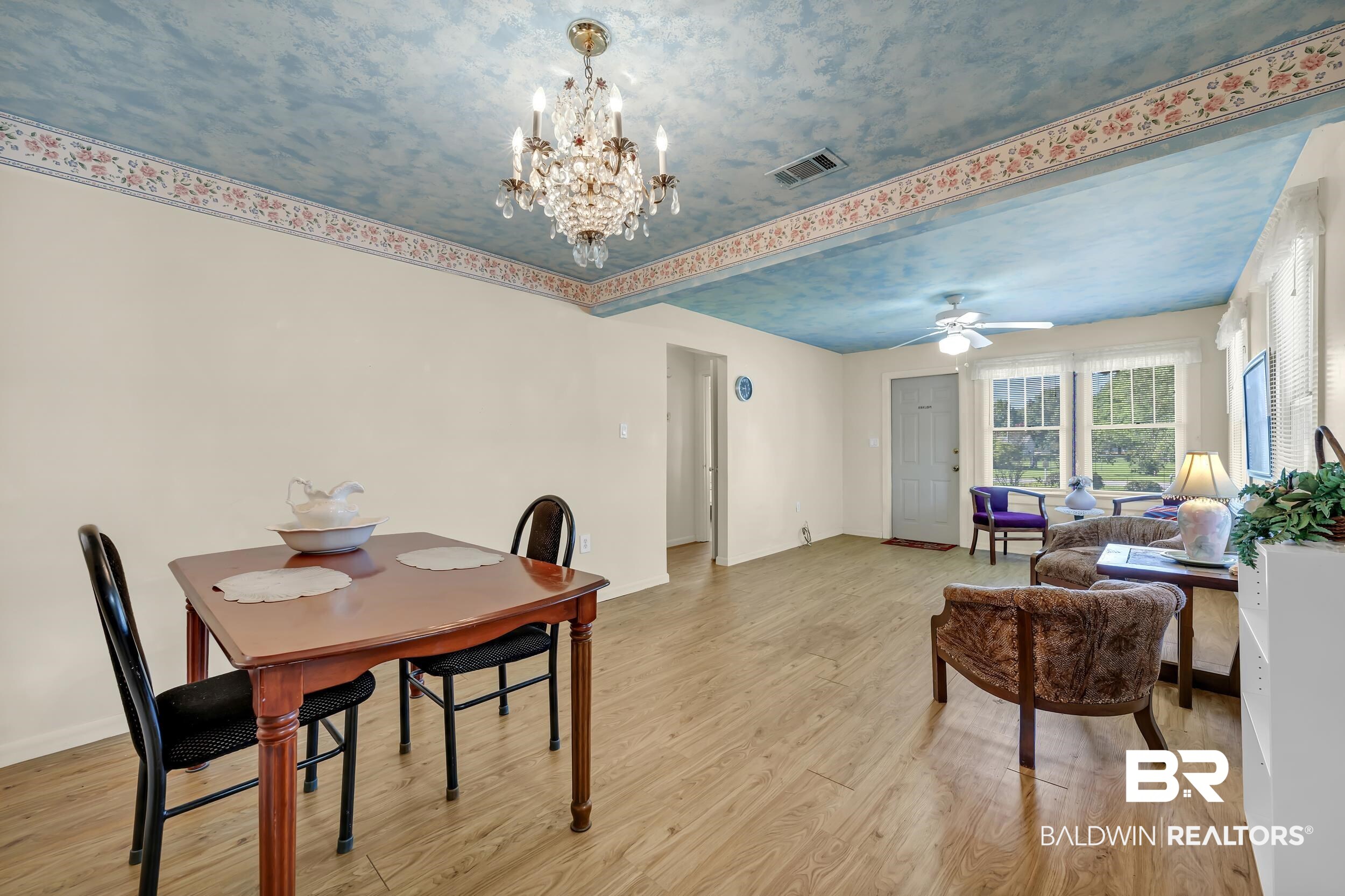 304 West Myrtle Avenue Foley, AL 36535 - Photo 5 of 29 Open-concept living space with wood-finish flooring, a decorative ceiling treatment, and a crystal chandelier