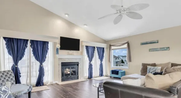 a living room with furniture fireplace and flat screen tv