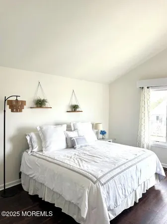 a bedroom with a bed and a night stand