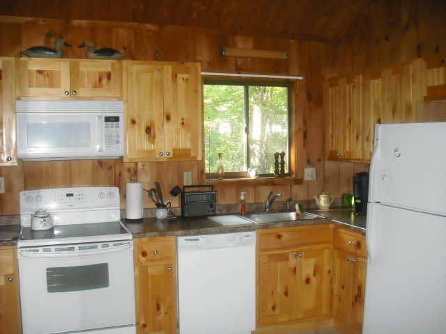 246 Stebbins Road Otis, MA 01253 - Photo 5 of 14 a kitchen with sink a refrigerator and a stove