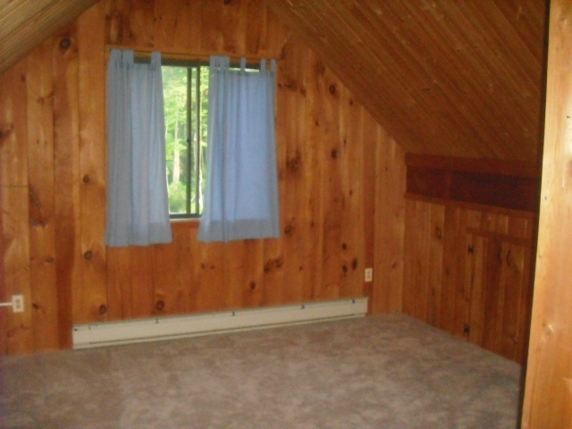 246 Stebbins Road Otis, MA 01253 - Photo 7 of 14 a view of a room with a window and a wooden door