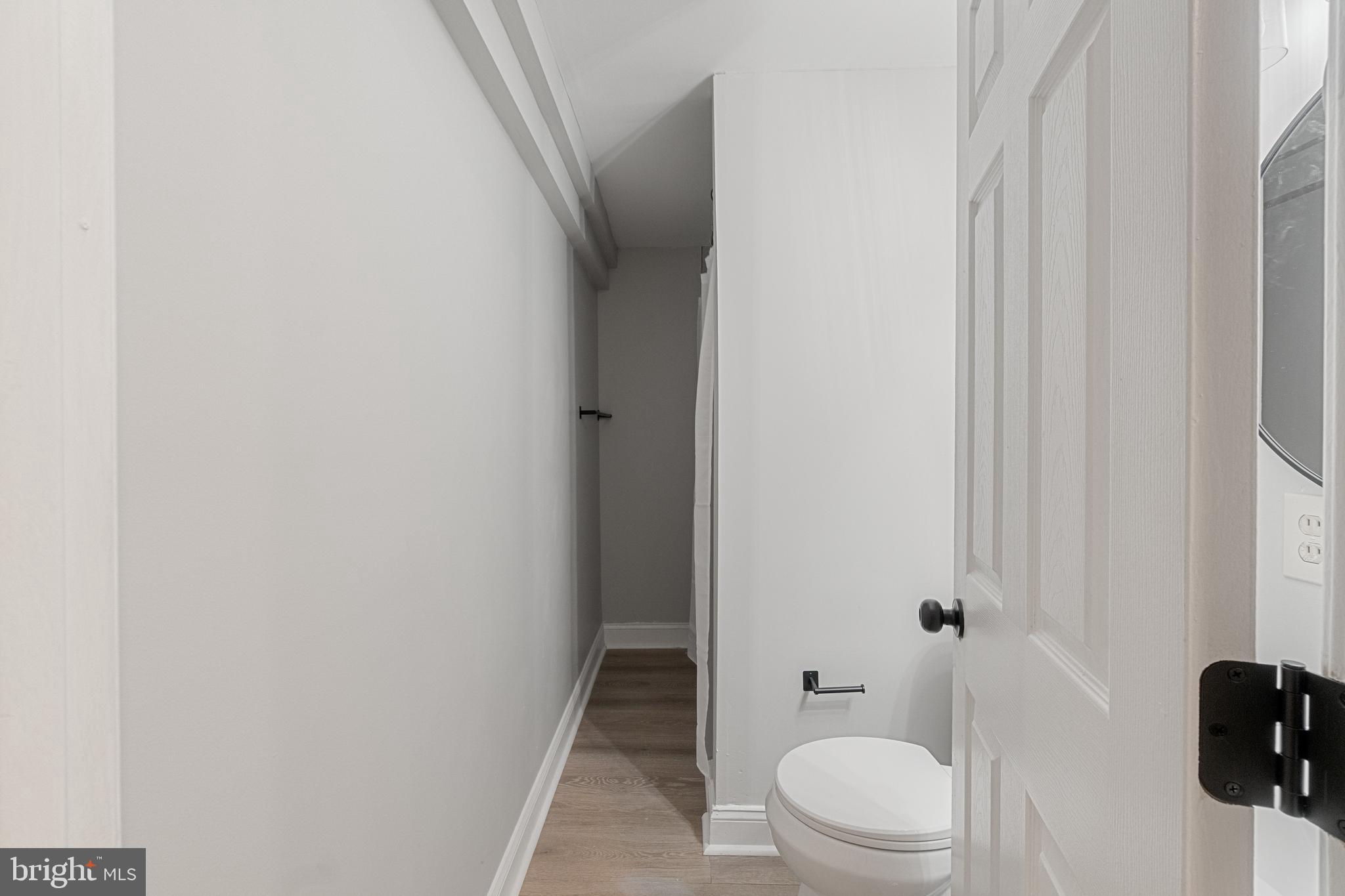 8546 Skipjack Place Pasadena, MD 21122 - Photo 15 of 20 a bathroom with a toilet and a shower