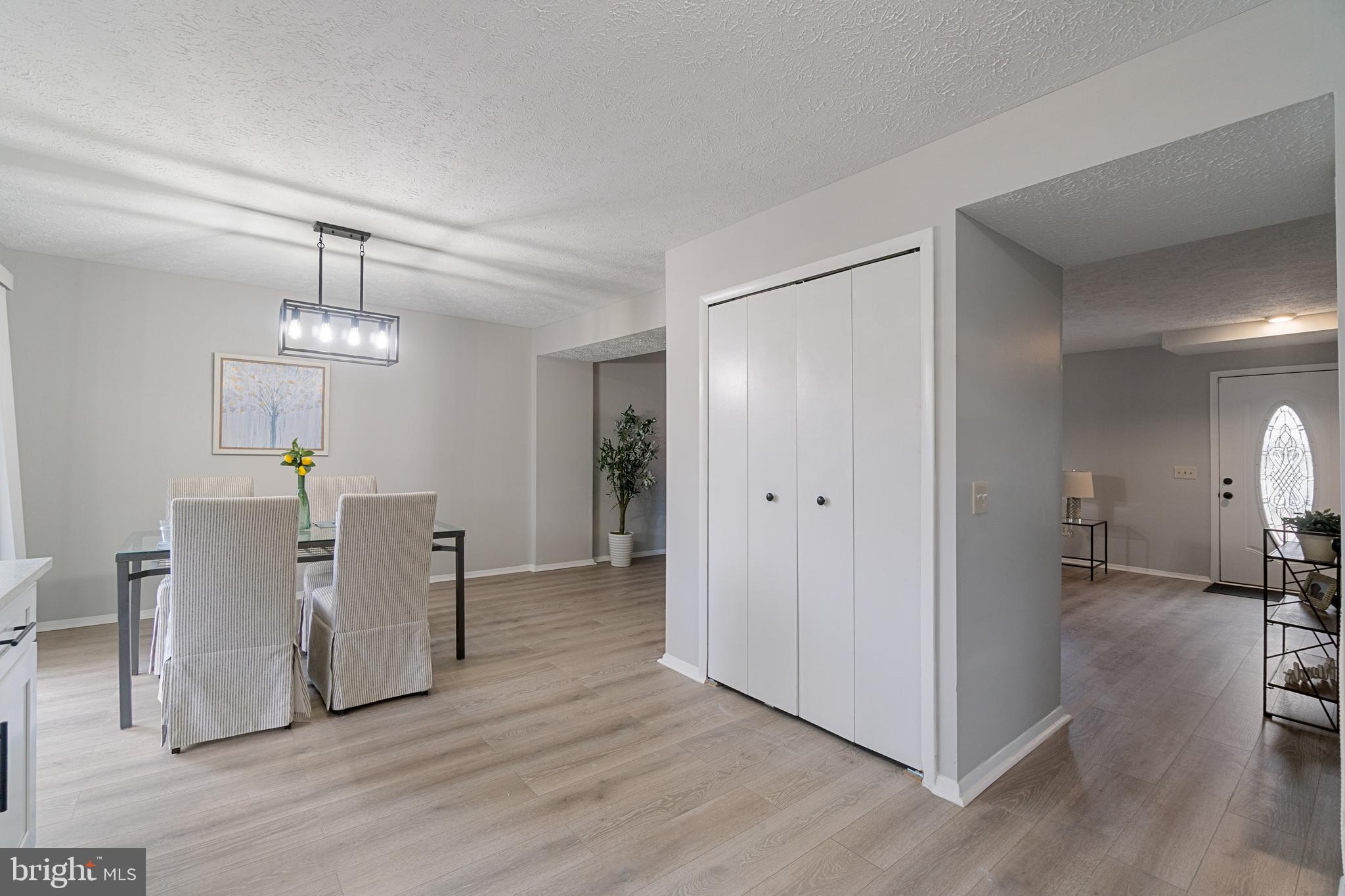 8546 Skipjack Place Pasadena, MD 21122 - Photo 6 of 20 a view of a dining room with furniture wooden floor and a chandelier
