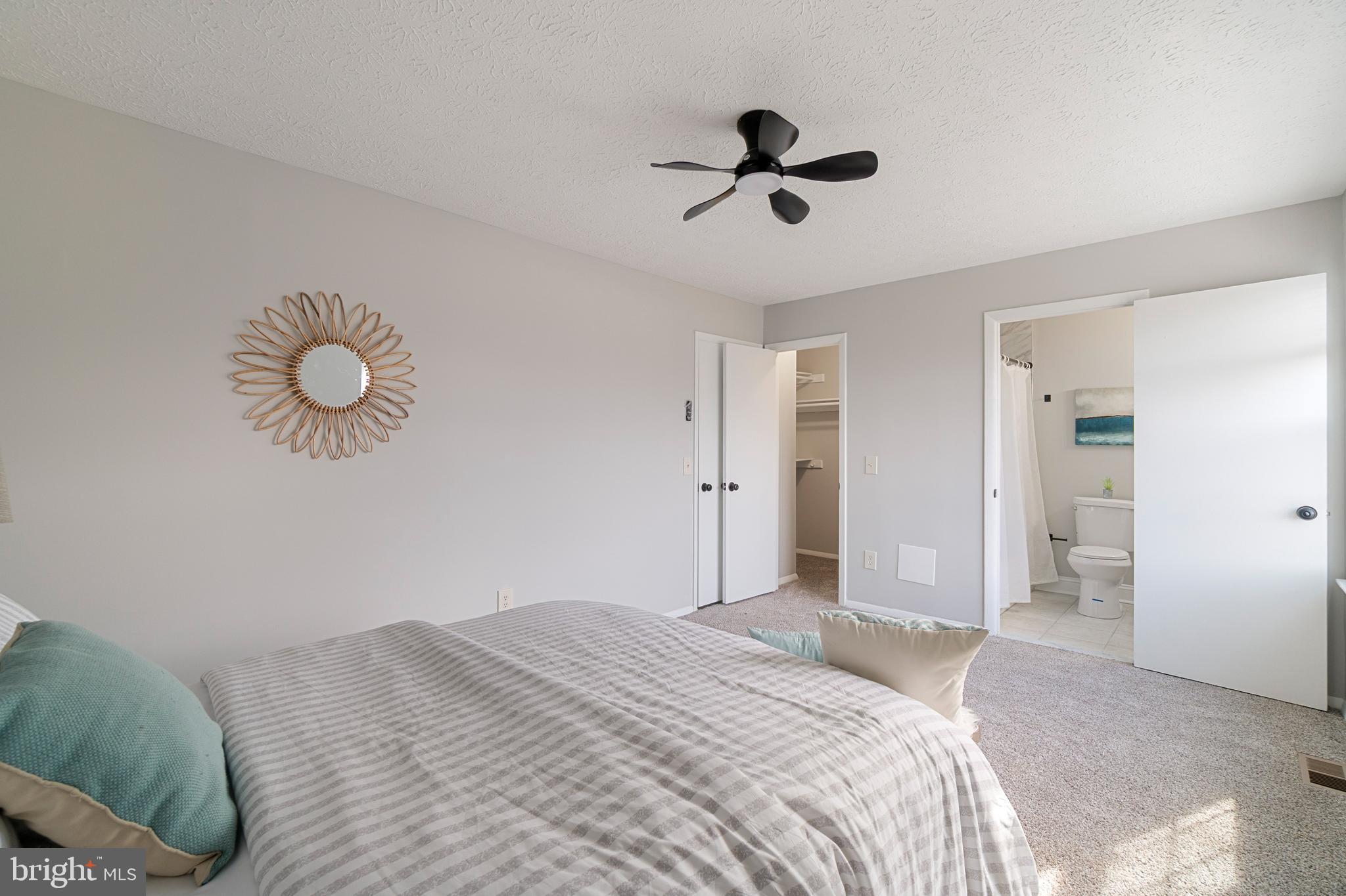 8546 Skipjack Place Pasadena, MD 21122 - Photo 8 of 20 a bedroom with a bed and a chandelier