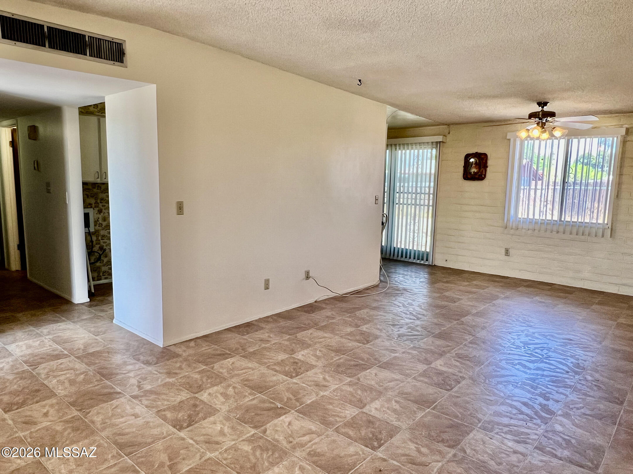 2955 South Kolb Road Tucson, AZ 85730 - Photo 9 of 24 View from Living Room of Backyard, Kitchen on other side of the wall and hallway leading to the bedrooms and bathrooms