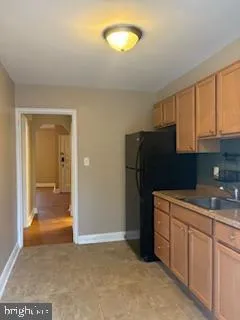 a kitchen with a refrigerator and cabinets