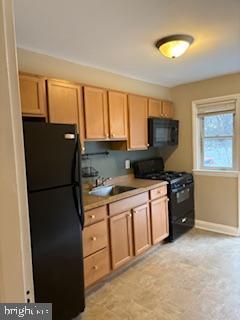 6166 Parkway Drive Baltimore, MD 21212 - Photo 7 of 9 a kitchen with a refrigerator stove and sink