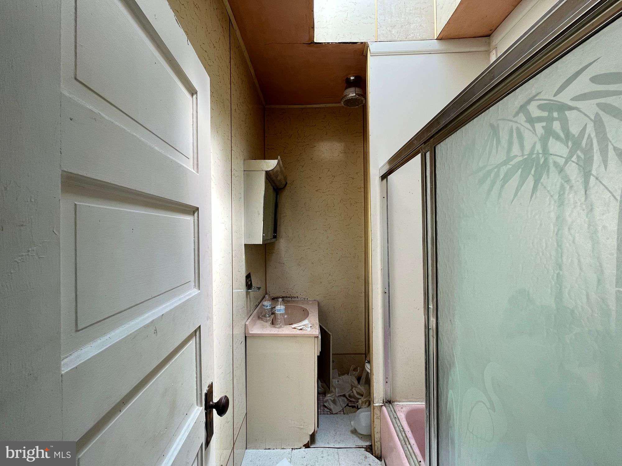 3606 Harlem Avenue Baltimore, MD 21229 - Photo 7 of 11 a bathroom with a sink toilet and shower