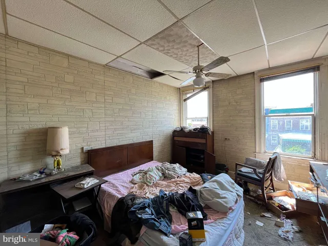 a bedroom with bed chair and window