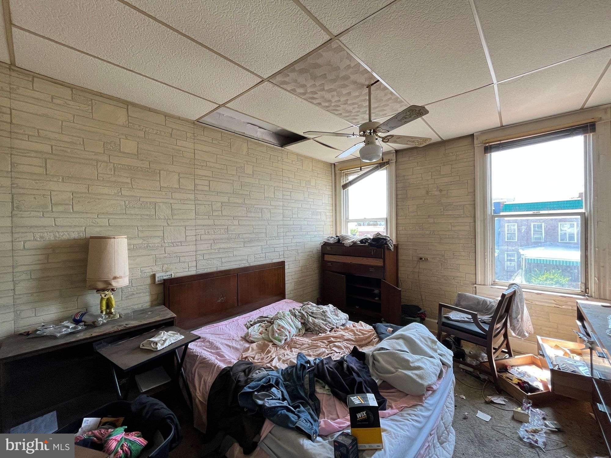 3606 Harlem Avenue Baltimore, MD 21229 - Photo 8 of 11 a bedroom with bed chair and window