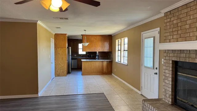 a view of a kitchen with a sink a refrigerator and window