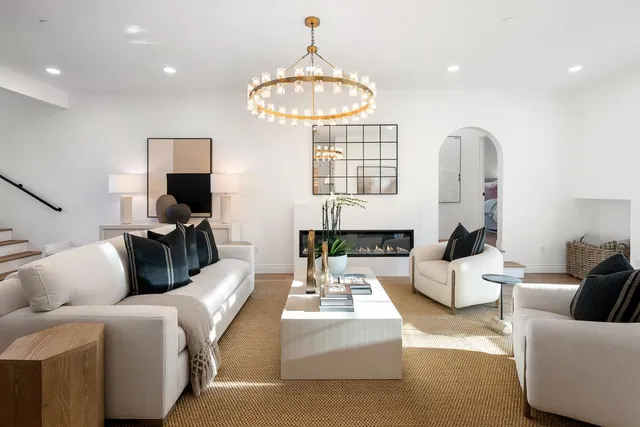 a living room with furniture and a mirror